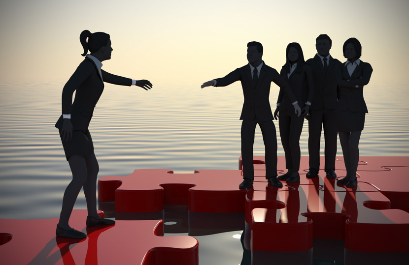 A successful team recruiting new staff like pieces of a jigsaw puzzle at sunrise by the sea.