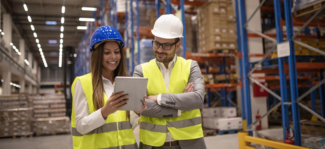 Managers controlling distribution and checking inventory in warehouse storage.