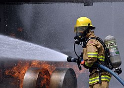 A Naval Air Facility Atsugi, Japan-based CNFJ Regional Firefighter douses out a live fire on a dummy aircraft during the baseís annual Off Station Mishap drill at Naval Support Facility Kamiseya, July 30. During the drill, emergency response and rescue teams were tasked with putting out a simulated fire, and rescuing two personnel from a plane crash scene.
